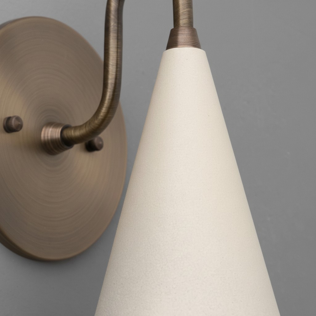 Close-up of Curva Metal cone shade and brass arm