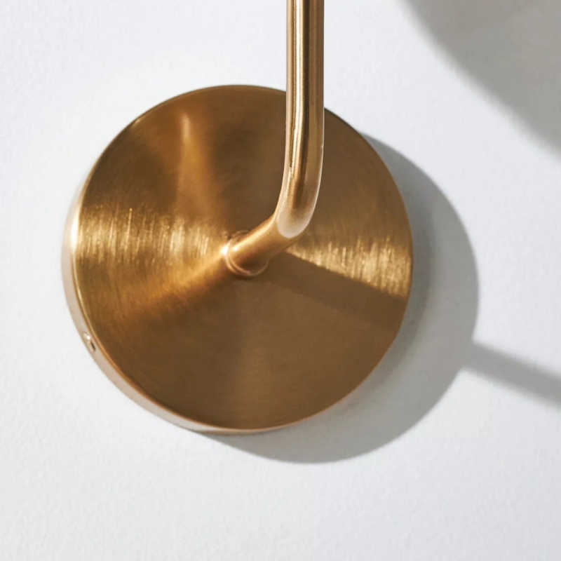 Close view of the brass stem and round wall plate