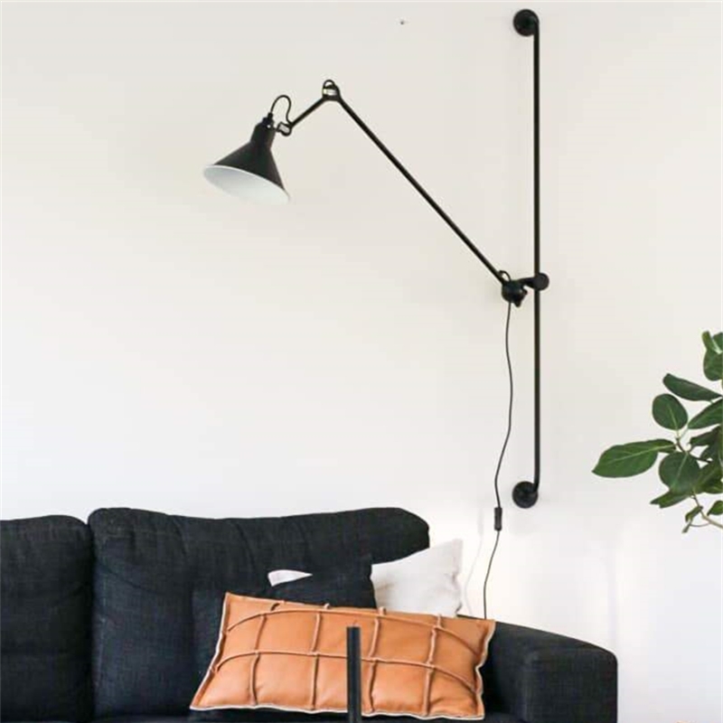 Swing arm wall light beside a sofa