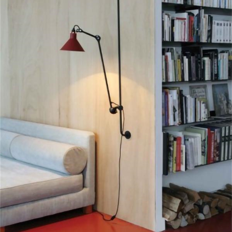 Swing arm wall light beside a sofa and bookshelf