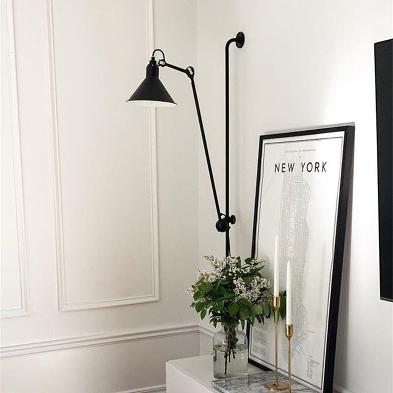 Black swing arm wall light in a bright interior