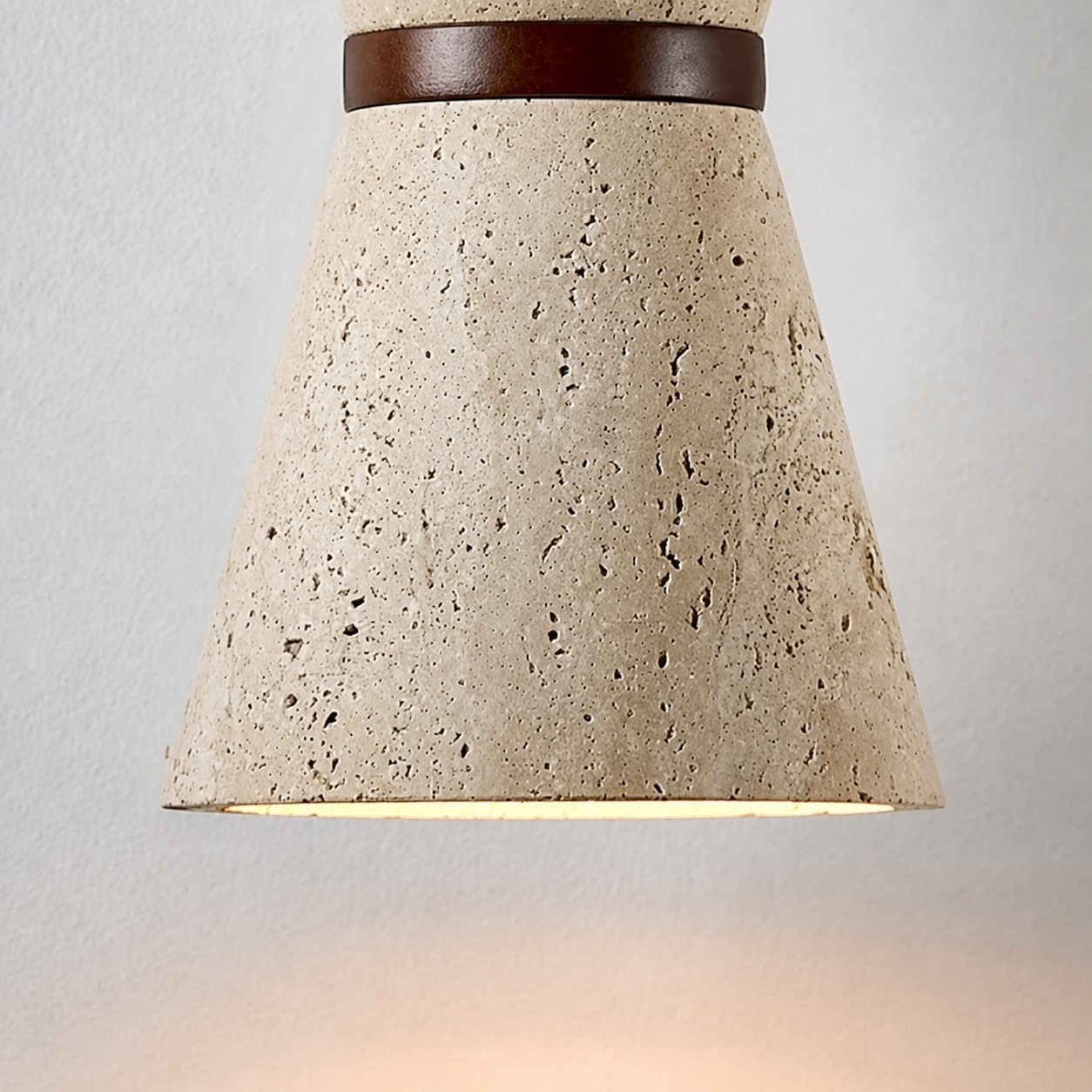 Illuminated travertine shade edge with warm glow