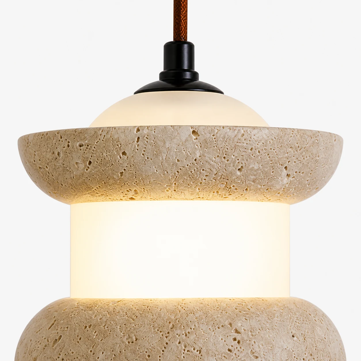 Close-up detail of the travertine stone pendant shade and warm finish