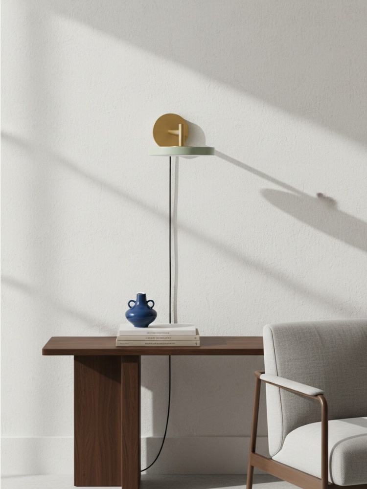 Asteria wall light in a minimal desk-side scene with visible cord