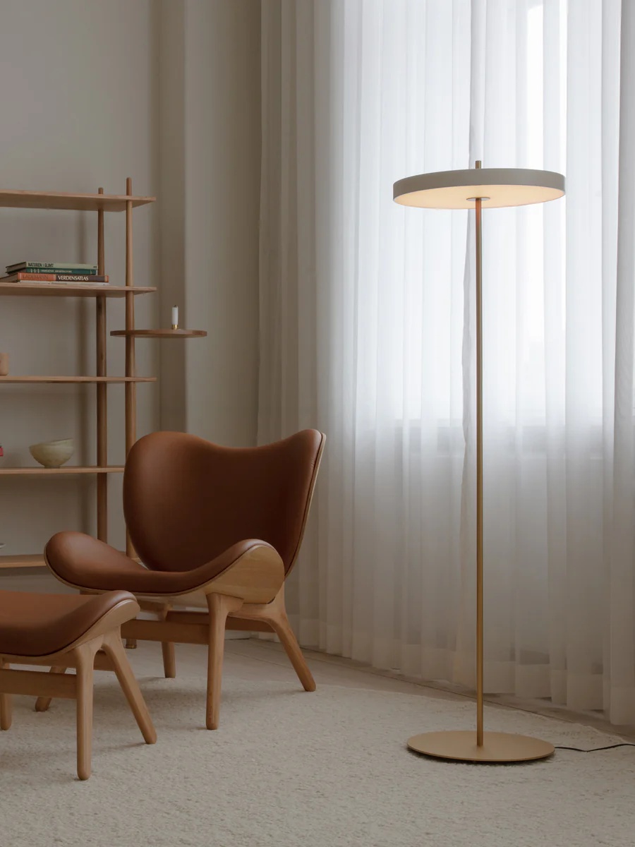Asteria lamp in minimal reading corner with chair and curtains
