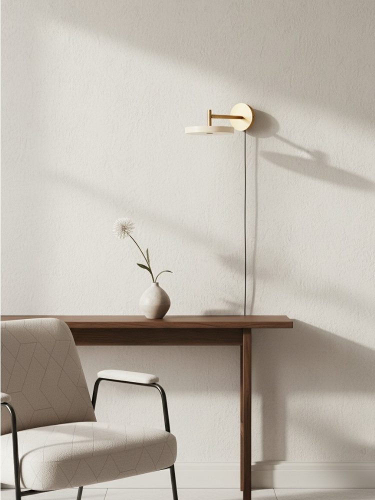 Asteria wall light above a desk and chair