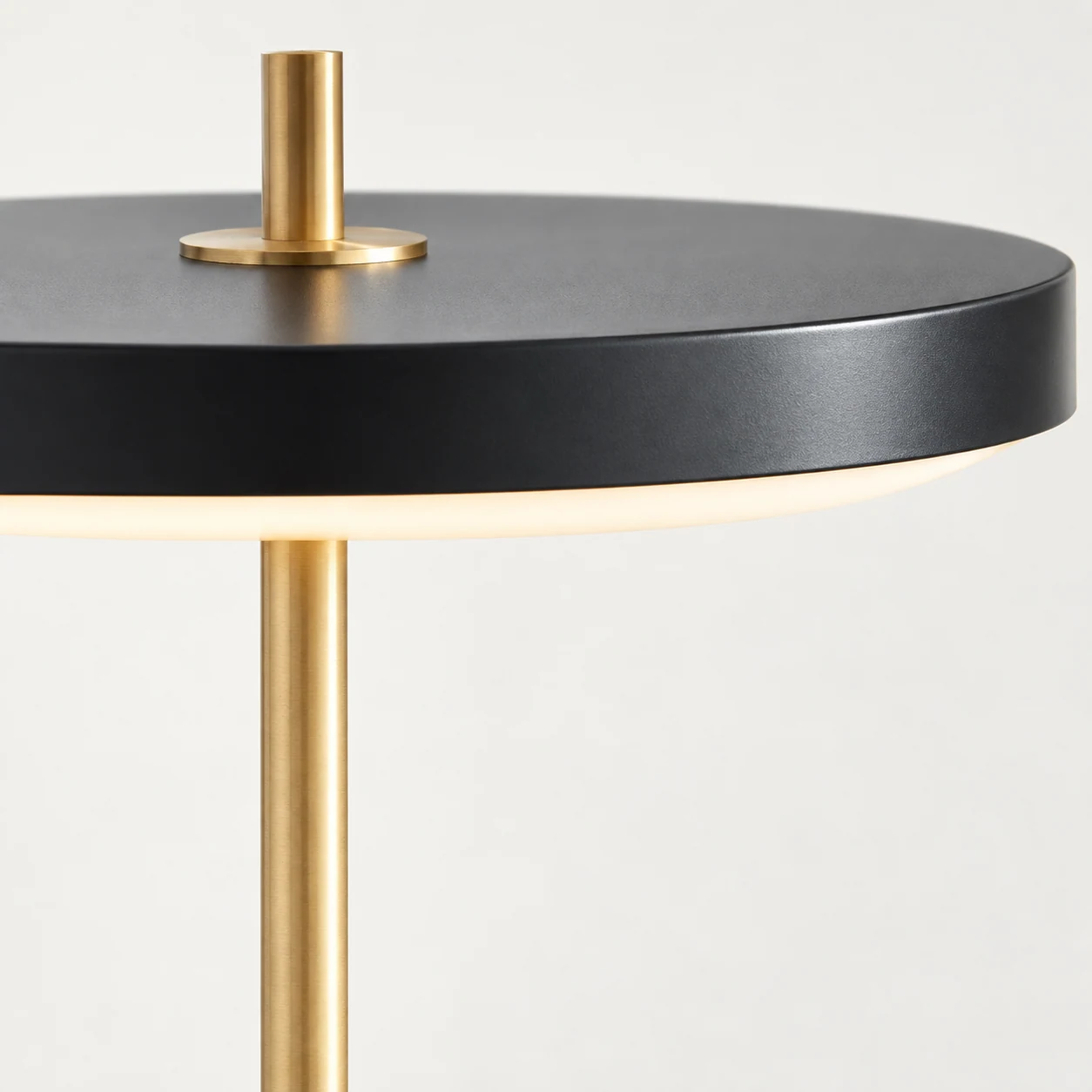 Close-up detail of the Asteria floor lamp shade and gold-toned construction