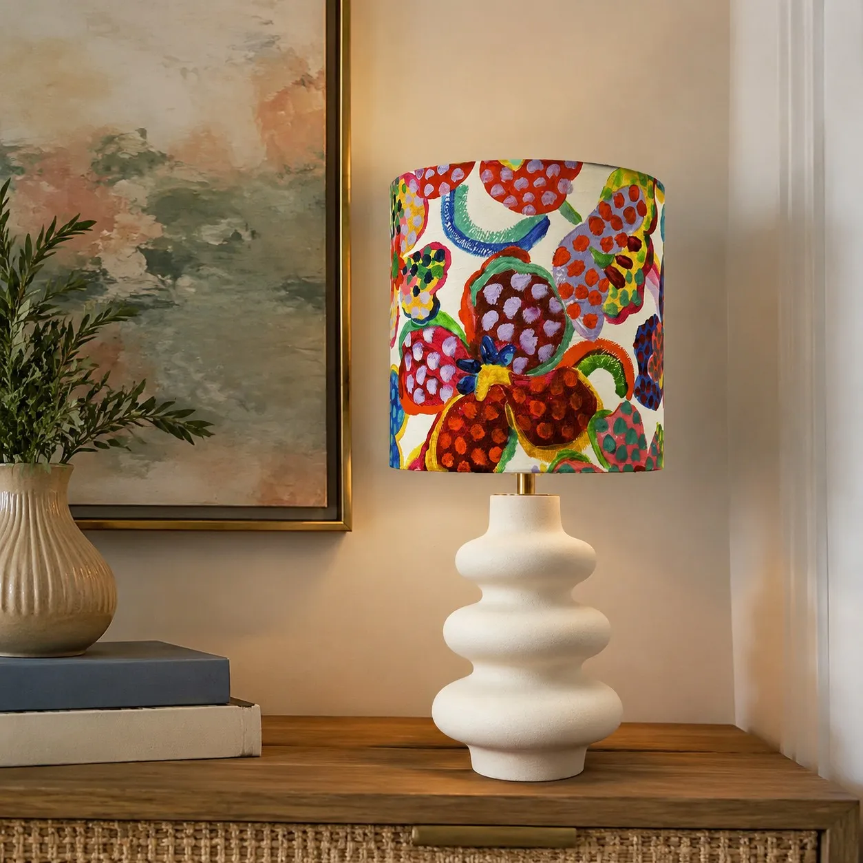 Colorful floral shade table lamp styled beside books