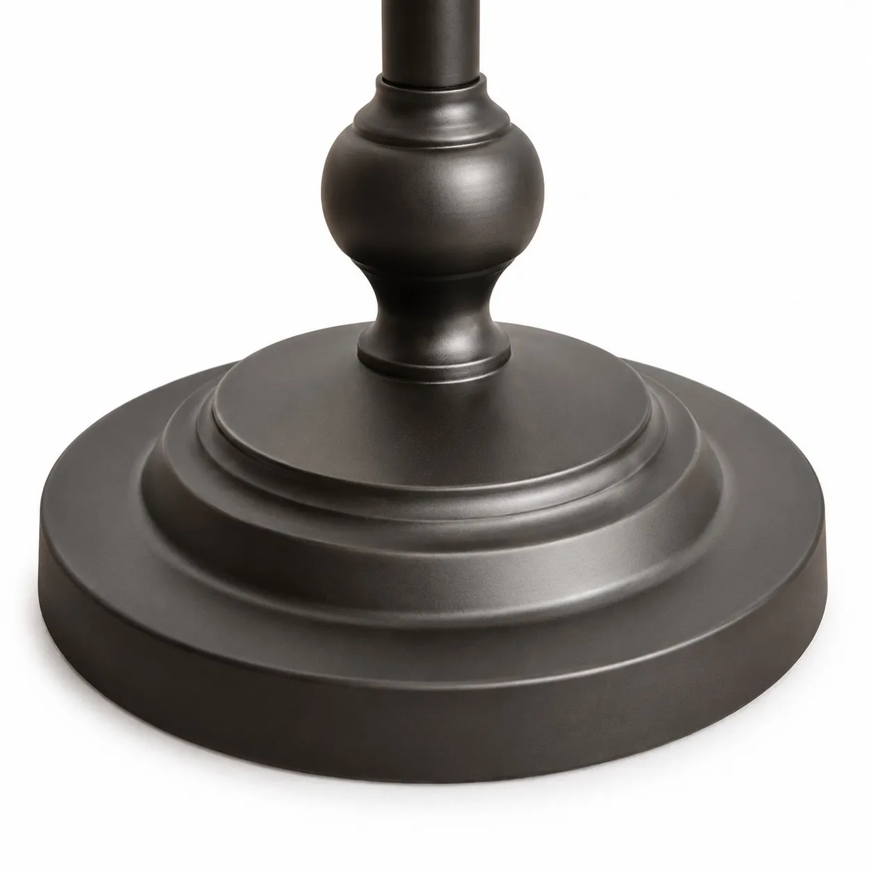 Close-up of the layered round base on the black metal floor lamp
