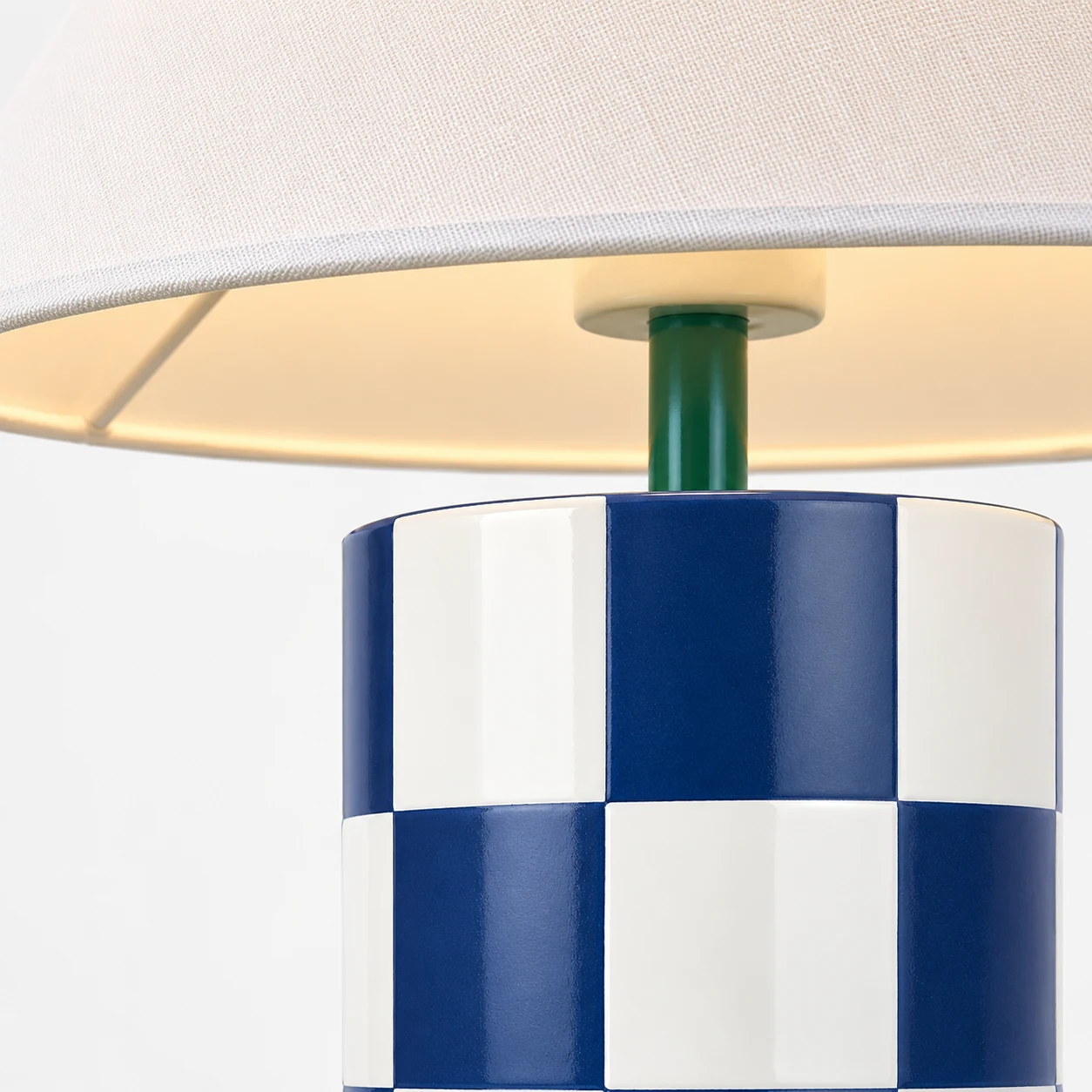 Close-up of the ceramic lamp's checkerboard finish and fabric shade